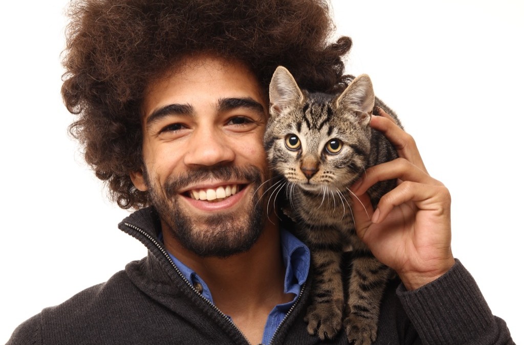 gilbert animal hospital - smiling person holding cat on shoulder